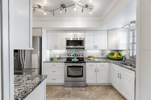 kitchen with stone counters, stainless steel appliances, and white cabinetry