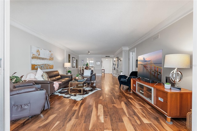 living room featuring dark wood-type flooring and ornamental molding