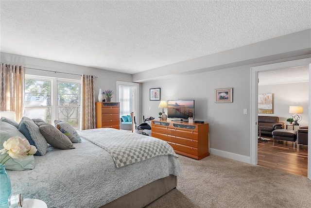 bedroom featuring carpet floors and a textured ceiling