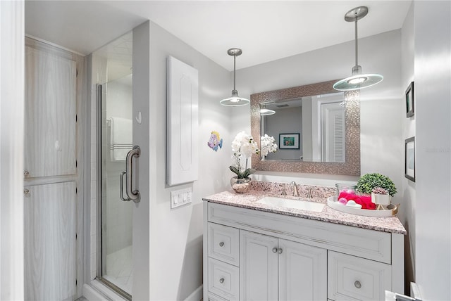 bathroom with a shower with door and vanity