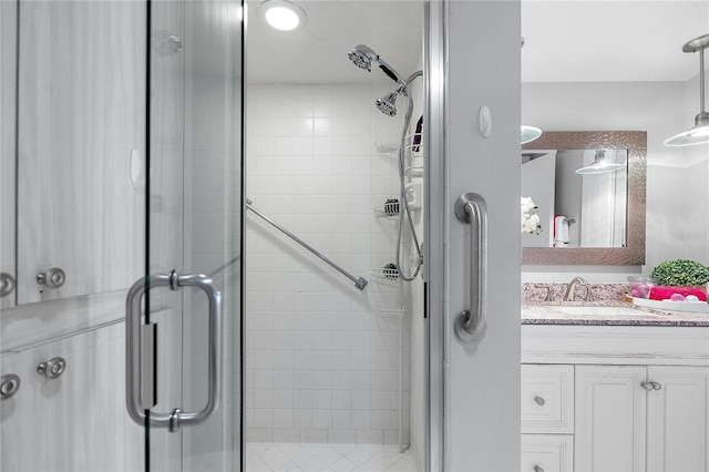 bathroom with vanity and a shower with door