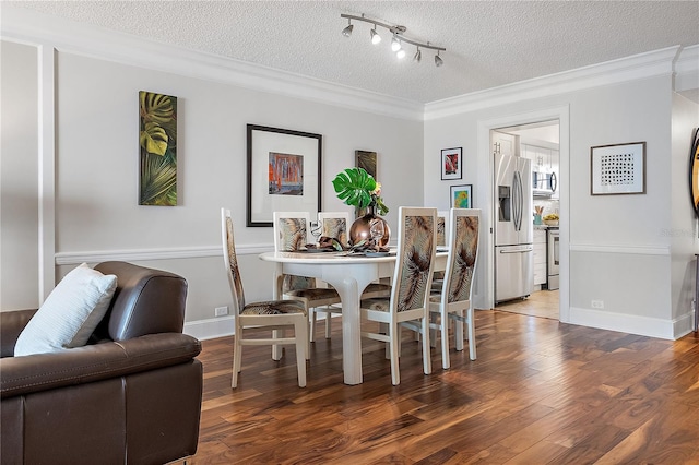 dining space with track lighting, crown molding, a textured ceiling, and hardwood / wood-style floors