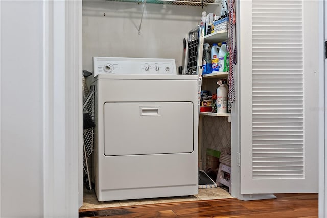 washroom featuring hardwood / wood-style floors and washer / clothes dryer