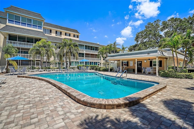 view of pool with ceiling fan and a patio area