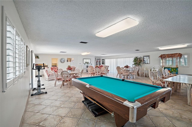 recreation room featuring billiards, light tile patterned floors, and a textured ceiling