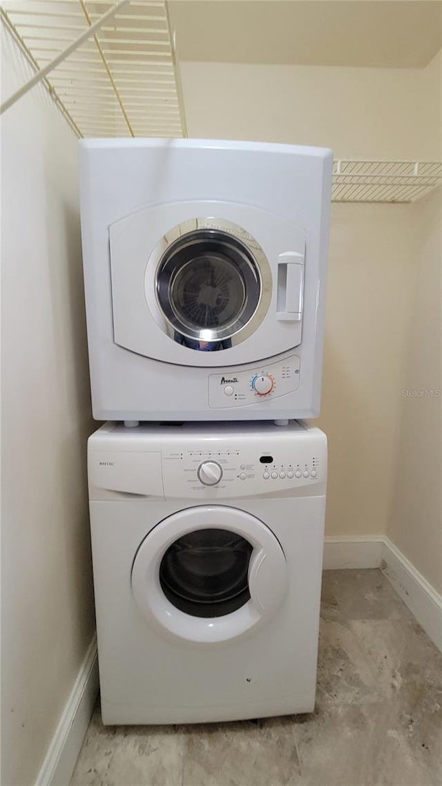 laundry area featuring stacked washer / drying machine