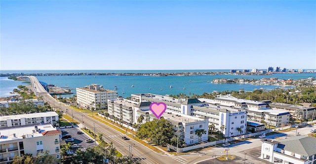 drone / aerial view featuring a city view and a water view