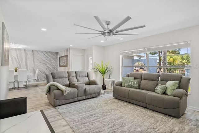 living room featuring ceiling fan and light hardwood / wood-style floors