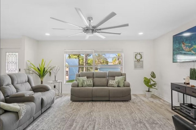 living room with light wood-type flooring and ceiling fan