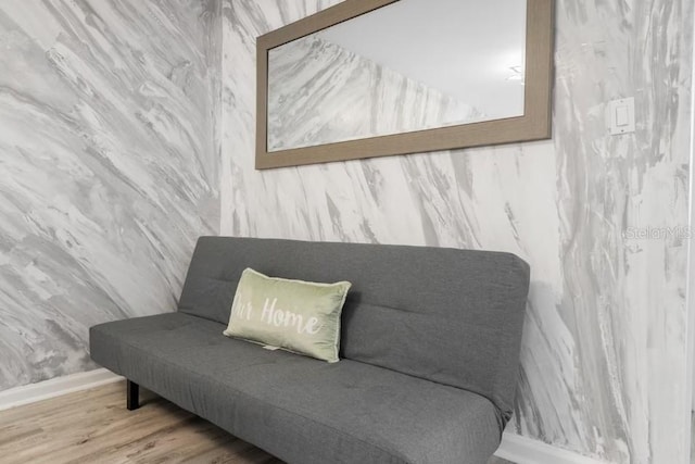 sitting room with wood-type flooring