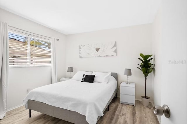 bedroom with hardwood / wood-style flooring