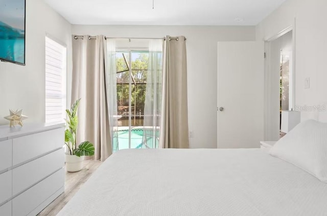 bedroom featuring light hardwood / wood-style floors and access to outside