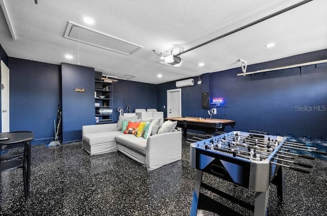 cinema featuring a textured ceiling and a wall unit AC