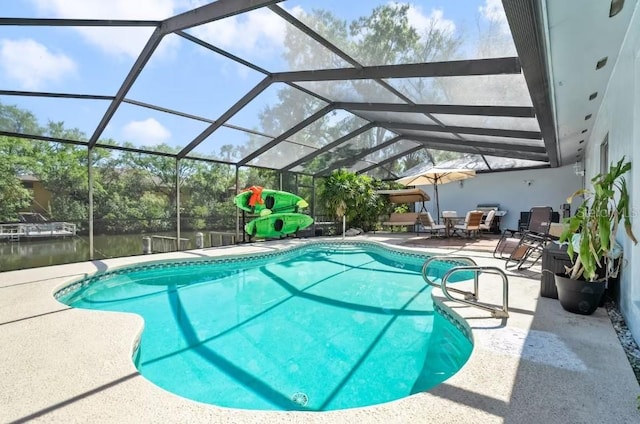 view of pool featuring a water view, a patio area, and glass enclosure