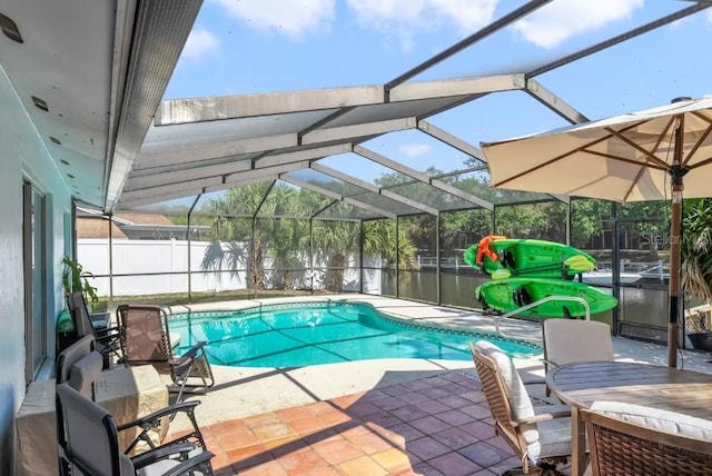 view of pool with a lanai, a patio area, a water view, and a jacuzzi