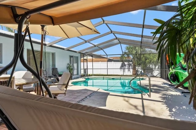 view of swimming pool featuring a patio and glass enclosure