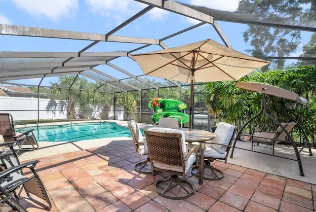 view of pool with a patio and glass enclosure