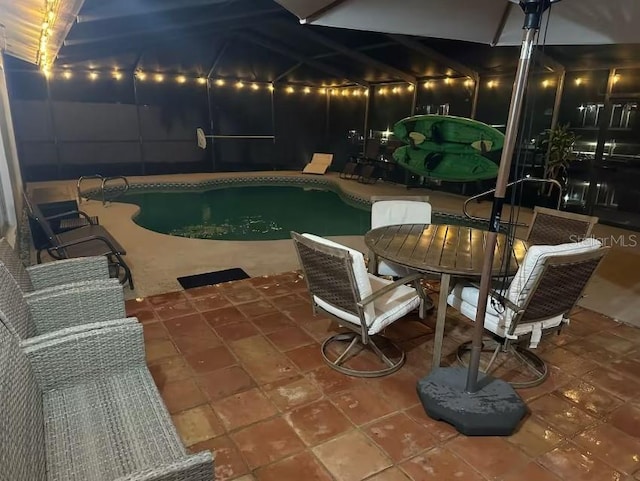 view of swimming pool with a lanai and a patio