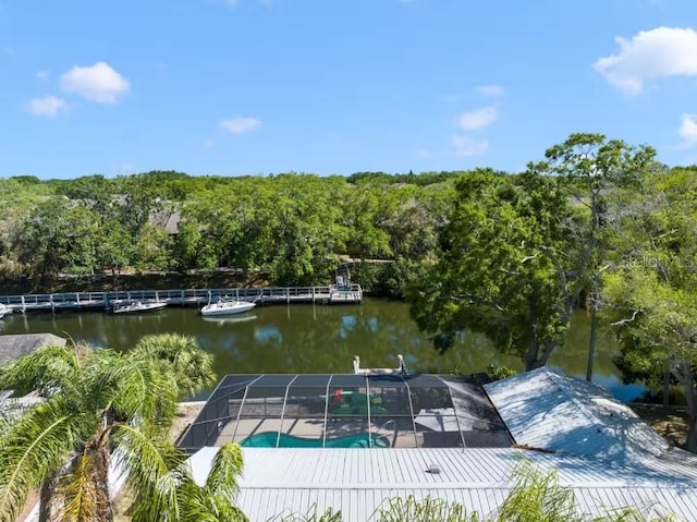 dock area with a lanai and a water view