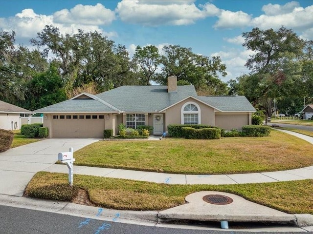 ranch-style home with a garage and a front yard