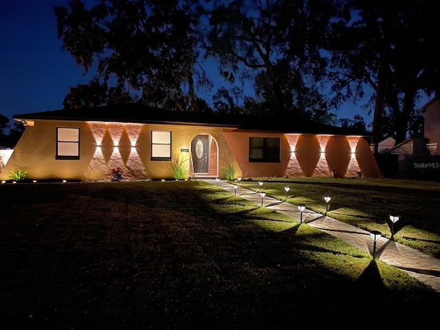 view of front of house with a yard