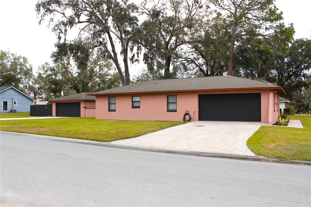 single story home with a front yard and a garage