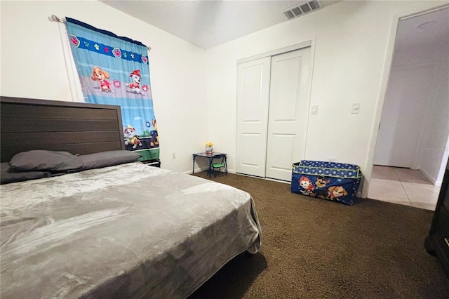 carpeted bedroom with a closet