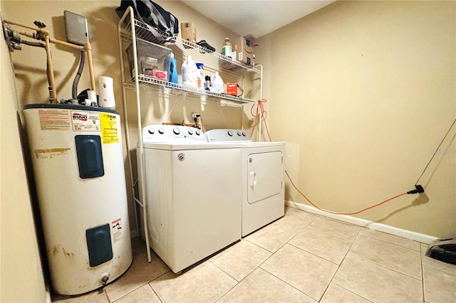 washroom featuring washing machine and clothes dryer, electric water heater, and tile patterned flooring