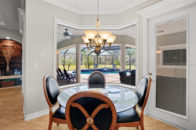 tiled dining area with ceiling fan with notable chandelier, ornamental molding, and plenty of natural light