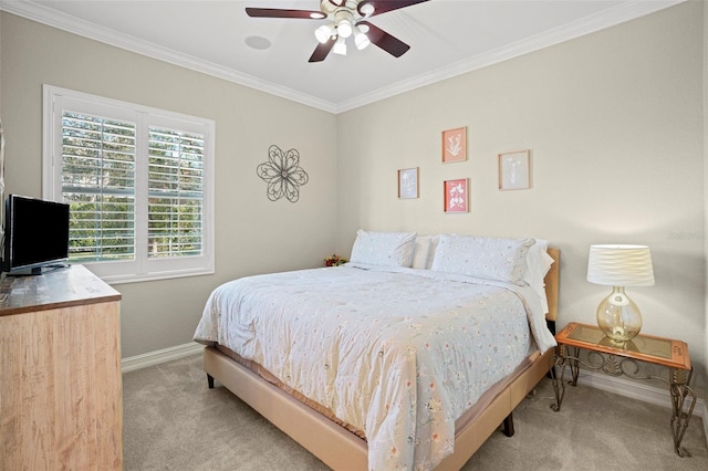 carpeted bedroom featuring ceiling fan and crown molding