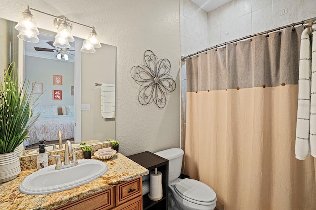 bathroom featuring ceiling fan, a shower with shower curtain, vanity, and toilet