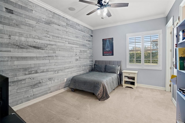 carpeted bedroom with ornamental molding, ceiling fan, and wooden walls