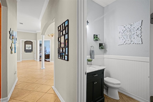 bathroom featuring tile patterned flooring, crown molding, vanity, and ornate columns