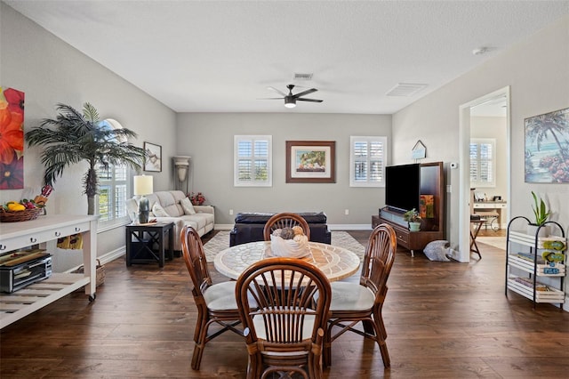 dining area featuring ceiling fan, plenty of natural light, and dark wood-type flooring