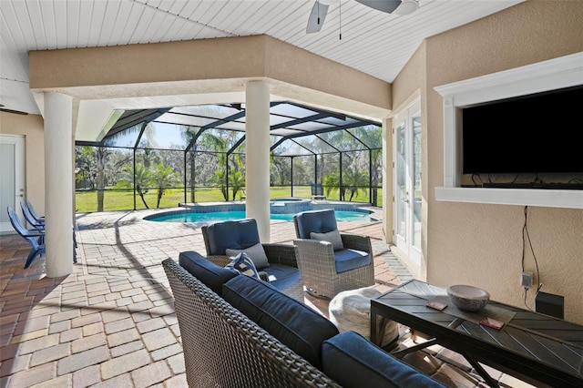 view of patio / terrace featuring an outdoor hangout area and glass enclosure