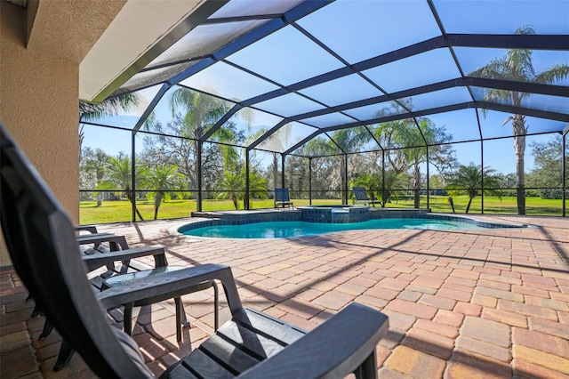 view of pool featuring a lawn, a patio area, an in ground hot tub, and glass enclosure