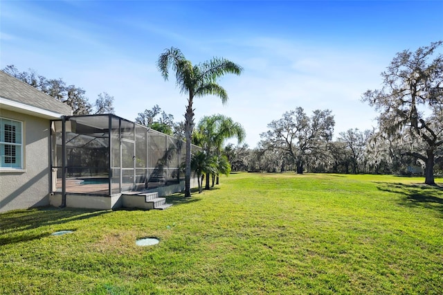 view of yard featuring glass enclosure