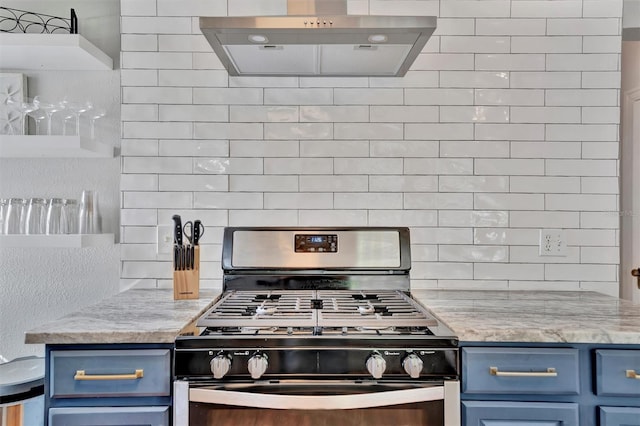 kitchen featuring gas stove, tasteful backsplash, range hood, and blue cabinets