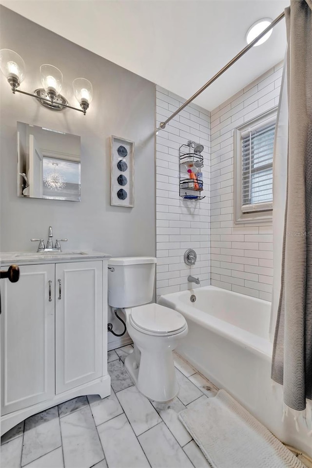 full bathroom featuring tiled shower / bath combo, toilet, and vanity