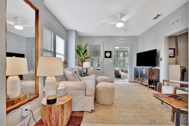 living room with ceiling fan and wood-type flooring