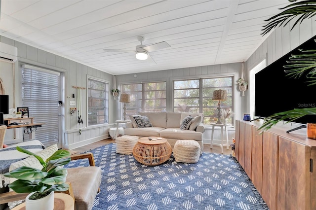 sunroom with a wall unit AC, ceiling fan, and wood ceiling