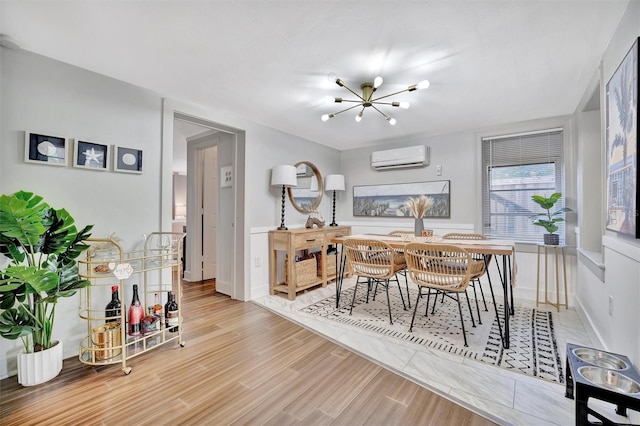 dining area with a wall unit AC and a chandelier