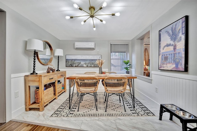 dining room featuring a wall unit AC and a chandelier