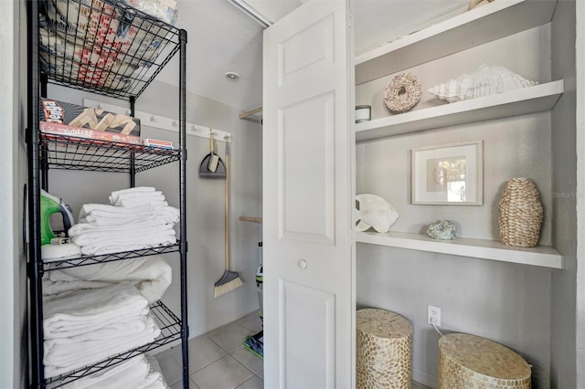 spacious closet with tile patterned floors