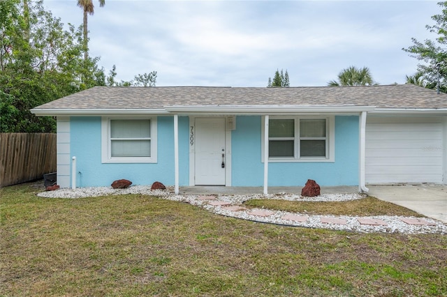 ranch-style home with a front lawn and a garage