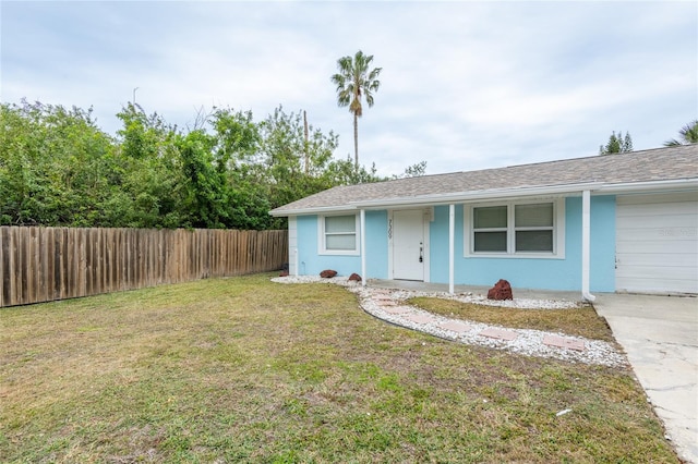 view of front of house featuring a garage and a front lawn