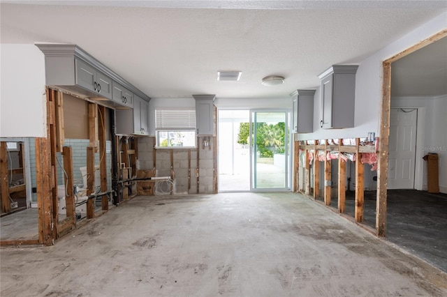 interior space featuring concrete floors and a textured ceiling