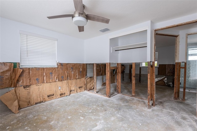 bedroom featuring ceiling fan, a closet, and concrete flooring