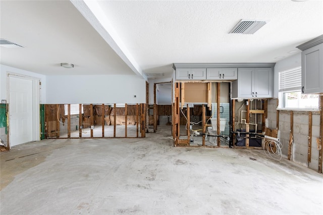 misc room with a textured ceiling and concrete floors