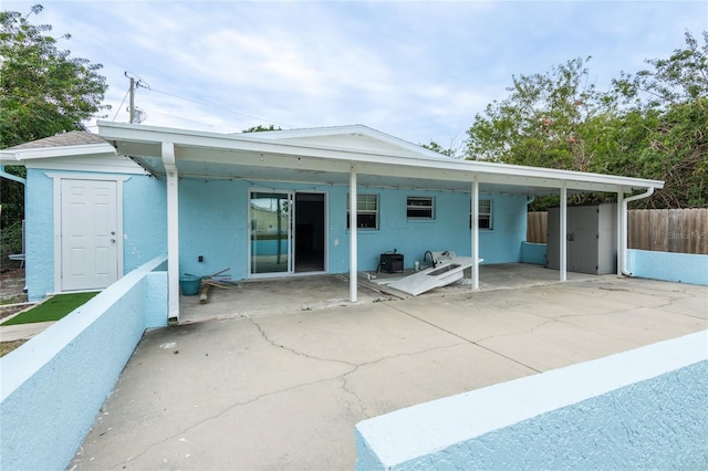 rear view of property featuring a carport